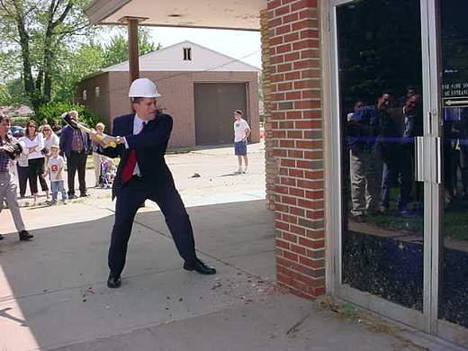 Dean swings a sledge hammer at the old Police Station on W. 54th Street