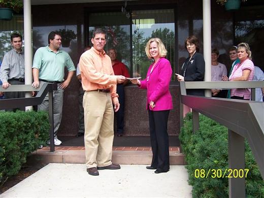 Mayor Dean DePiero presents the $5750 donation check from the 2007 Mayor's 5K Run to Kristin Graham, Administrator at Holy Family Home. The race was held on June 9th and benefited the Holy Family Home.